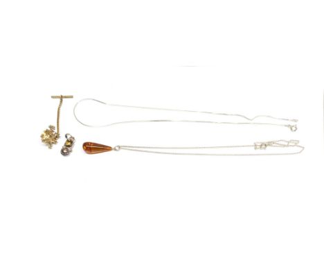 A silver  and amber pendent and chain, silver stone set pendant and chain and a silver lion stick pin.