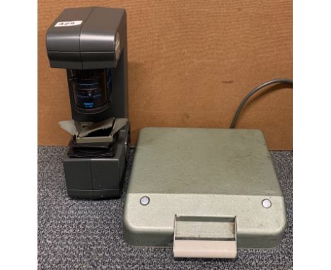 A Tamron Fotovix slide/negative viewer and a vintage typewriter.