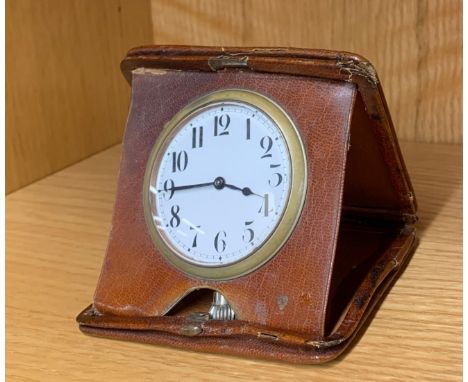 A Goliath pocket watch travelling clock with folding leather case, case size 11 x 10cm.
