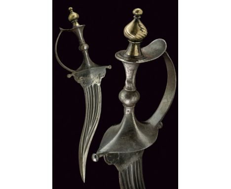 A dagger dating: mid-19th Century provenance: India Curved, double-edged blade with strangthened and ribbed tip, provided wit