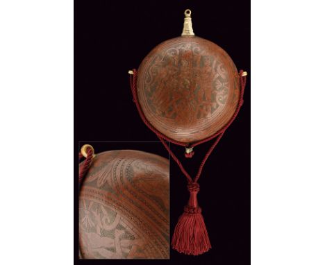 A powder-flask dating: 19th Century provenance: Italy Oval body made of a pumpkin, finely engraved with effigy of human figur