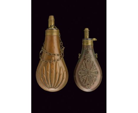 A lot of two powder-flasks dating: mid-19th Century provenance: Europe Metallic flask decorated with bas-relieved floral moti