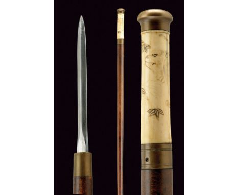 A stick-sword dating: late 19th Century provenance: Japan Almost cylindrical, wooden barrel, with grip of light horn chiselle