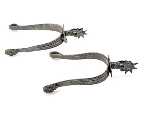A pair of spurs dating: 18th Century provenance: Indopersia Iron spurs, the arch engraved and sculpted, with loops for the le