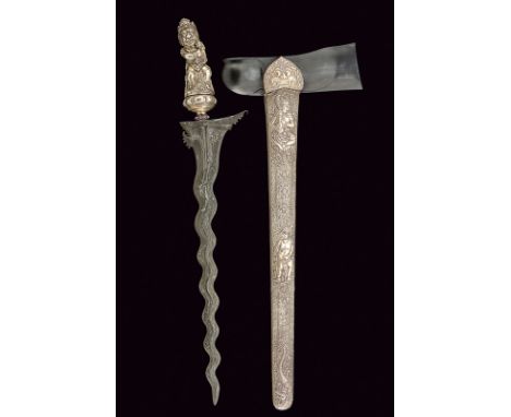 A big silver mounted kriss dating: 20th Century provenance: Bali Undulated, double-edged blade of fine pamor, ribbed at the c