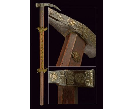 A silver decorated war-hammer dating: 17th Century provenance: Eastern Europe Iron head with long beak strongly curved toward