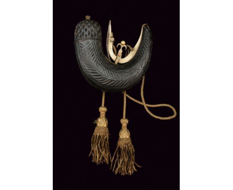A powder-flask dating: 19th Century provenance: Indopersia Strongly curved body with leather covering (small parts missing), 