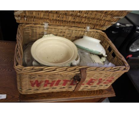 Wicker hamper worded 'Whiteleys Laundries' (worm damage), containing some ceramic dinner wares