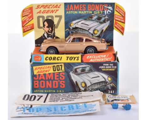 Corgi Toys 261 James Bond Aston Martin D.B.5 from the Film “Goldfinger” gold body, with ejector seat, bandit and James Bond f