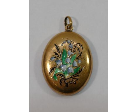 A Victorian oval gold pendant locket,the front decorated in enamel with blue bells, with hinged engine turned back panel, 3cm