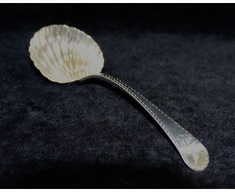A George II sauce ladle, London 1738, with shell pattern bowl and feather edge decoration to the handle, 1.42ozt, 45g, 18.2cm