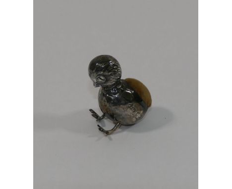 A miniature silver pin cushion in the form of a chick in an egg, Birmingham 1910, with registration no. 575461, 3cm high - Pa