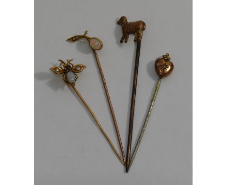 An opal, half seed pearl and garnet set gold insect tie pin, an opal set tie pin stamped '15CT', a Victorian tie pin with hea