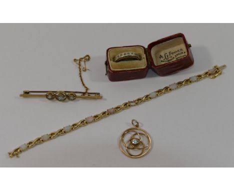 A 15 carat gold bar brooch, set with three aquamarines, with steel pin, 3.7g gross, a circular openwork pendant, set with sin