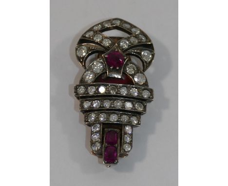 A single Art Deco gold and silver ruby and diamond clip, set with three mixed cut rubies and 41 pave set small round brillian
