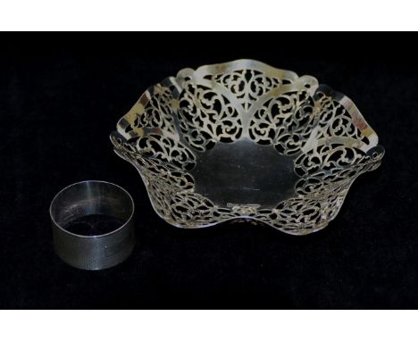 A silver bon bon dish with pierced decoration, Birmingham 1965, 14.5cm diameter, and a circular napkin ring with engine turne