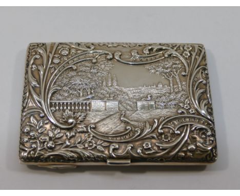 A late Victorian silver calling card case, with hinged back, Birmingham 1899 by Henry Matthews, with repousse vignettes of tw