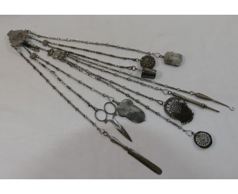A Georgian bright cut steel chatelaine, the ten chains terminating in a pair of scissors, paper knife, acorn shaped aide memo