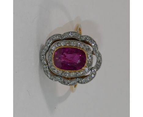 An Art Deco style ruby and diamond dress ring, the central cushion-shaped mixed cut ruby approximately 2.1 carats, in yellow 