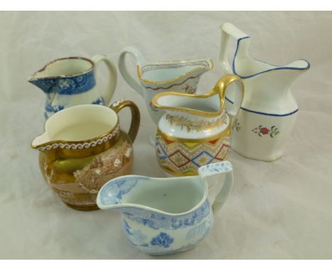 Six 18th century and 19th century cream jugs including a pearlware helmet-shaped jug, possibly Leeds, decorated in polychrome