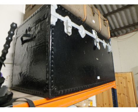 A LARGE PAINTED BLACK WOODEN TRUNK