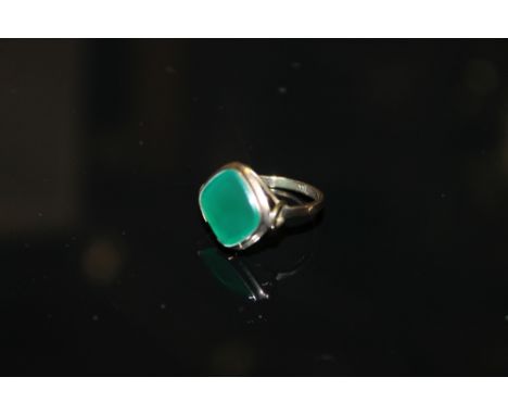 A YELLOW METAL RING STAMPED 333 SET WITH A LARGE JADE GREEN  STONE