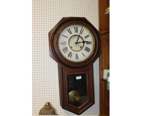 A LARGE OAK FRAMED VINTAGE WALL CLOCK