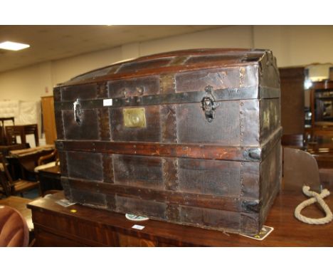 A BANDED DOMED TRAVEL TRUNK