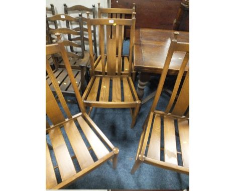 A SET OF FOUR ERCOL OAK DINING CHAIRS