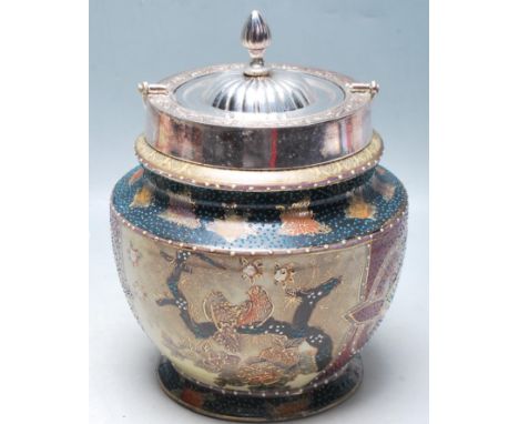 A Meiji Revival Imari style ceramic biscuit barrel having a finial topped silver plated lid and handle with polychrome decora