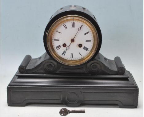 An antique 19th Century Victorian slate 8 day barrel mantel clock. The clock having a circular hood, white clock face, roman 