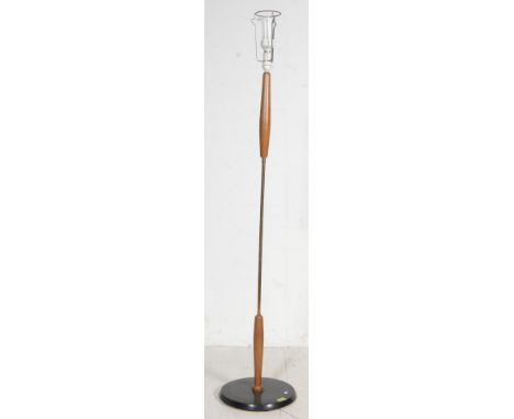 A retro vintage 1960’s teak wood standard floor lamp of upright form having turned column with brass shaft raised on a circul