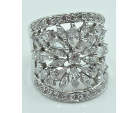 A large .925 silver ladies dress ring having a large blooming flower set with swarovski crystals. Made by The Real Effect of 