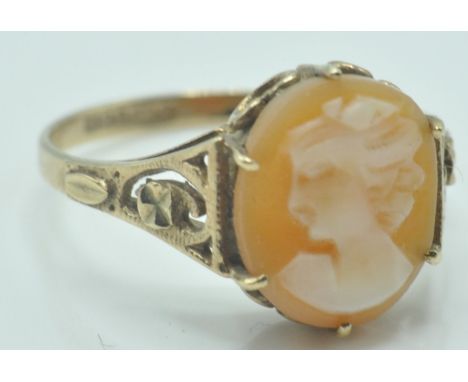 A 9ct gold ring hallmarked for Birmingham, 1978. The ring having an oval carved cameo depicting a maiden having pierced and s