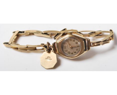 A vintage 20th Century 9ct gold Rotary wrist watch having a round face with gilt arabic numerals to the chapter ring on an ex