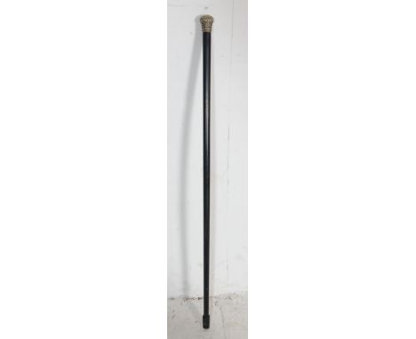 An early 20th Century English gentleman's swagger stick / evening cane. The ebonised wooden cane having a silver plated white