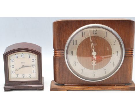Two 1950’s Smiths electric clocks to include a Smiths Sectric wooden mantel clock having 200/250v electric movement and a Smi