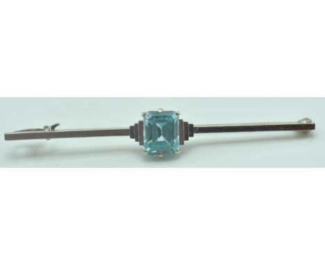A 1930’s Art Deco 9ct and 14ct white gold and blue octagon step cut blue zircon flanked by a stepped terraced setting to knif