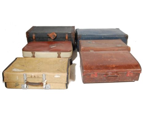 A collection of six vintage 20th century leather suitcases and travel trunks to include brown cases, cream colour suitcases, 