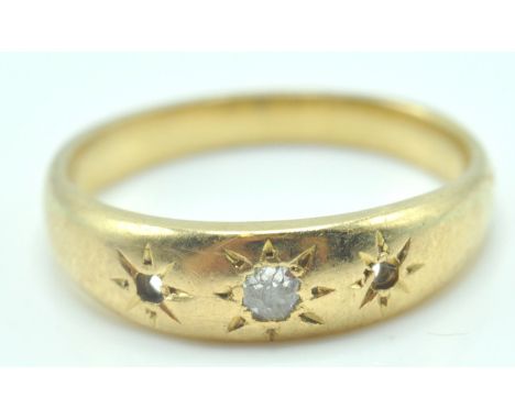 An 18ct gold (unmarked) and diamond gypsy ring. The ring with stones missing having starburst settings to tapering shoulders 