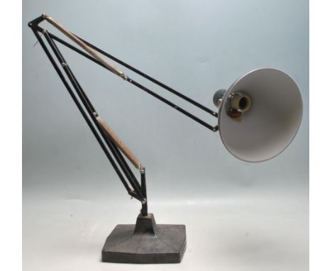 A vintage 20th Century Herbert Terry Anglepoise industrial desk lamp finished in a black enamel colourway. Raised on square b