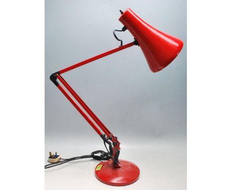 A vintage 20th Century Herbert Terry Anglepoise industrial desk lamp finished in red enamel colourway. Raised on circular bas