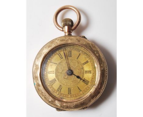 A mid 20th Century 9ct gold fob pocket watch of small proportions having an intricately engraved case with a gilt face and ro