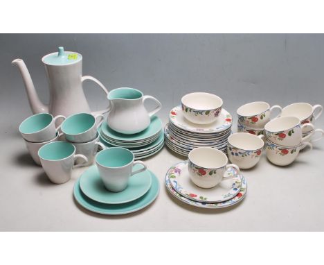 A vintage 20th century Poole pottery two tone tea set comprising of a teapot, six cups, saucers and a milk jug together with 