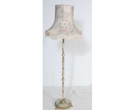 A vintage mid century onyx brass standard lamp having green marble and brass turned column with circular base raised on three