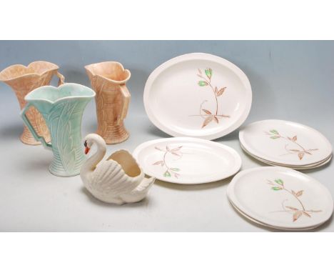 A collection of three 1920’s Art Deco jugs by Arthur Wood of tapered form with geometric angular handle, scalloped rim, embos