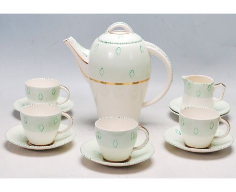 An early 20th century Art Deco 1930s Tams ware four person tea service comprising of cups, saucers &amp; teapot. The service 
