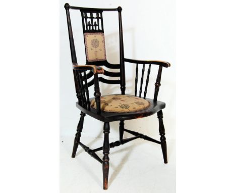 A 19th century Victorian Arts and Crafts style mahogany chair / elbow chair having pierced splat with a padded central panel 