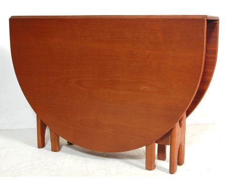 A retro 1970's G Plan teak wood drop leaf dining table having square leaves with rounded top extending on a gate leg action. 