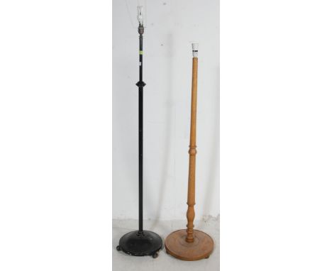 Two early 20th century standard lamps comprising of an ebonised metal lamp having a&nbsp;circular base with bun feet. Togethe